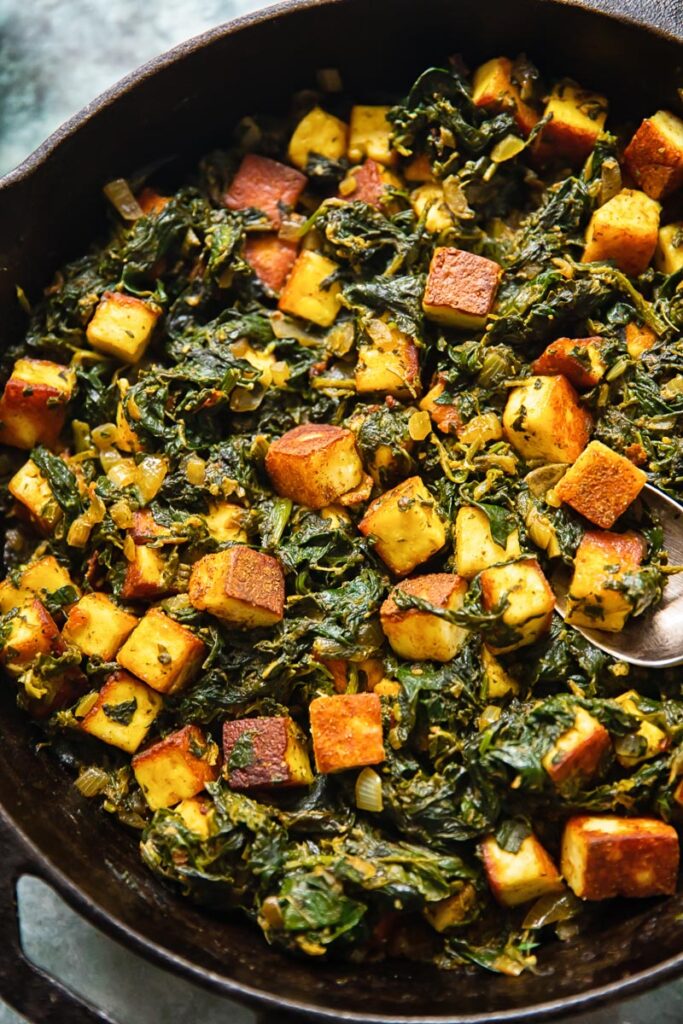 Top down view of saag paneer in a cast iron pan