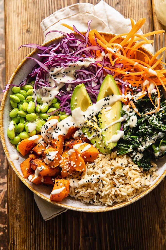 Buddha bowl with dressing on a wooden table