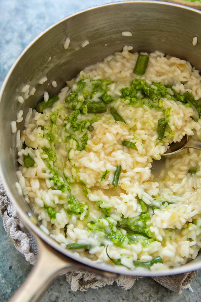 Pot of risotto with drizzled pesto