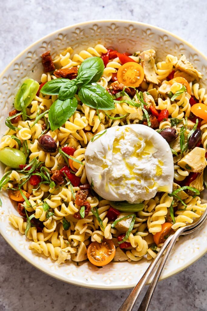 Top down of a bowl of pasta salad with burrata