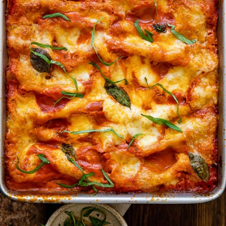 Top down view of spinach and ricotta cannelloni in a baking dish