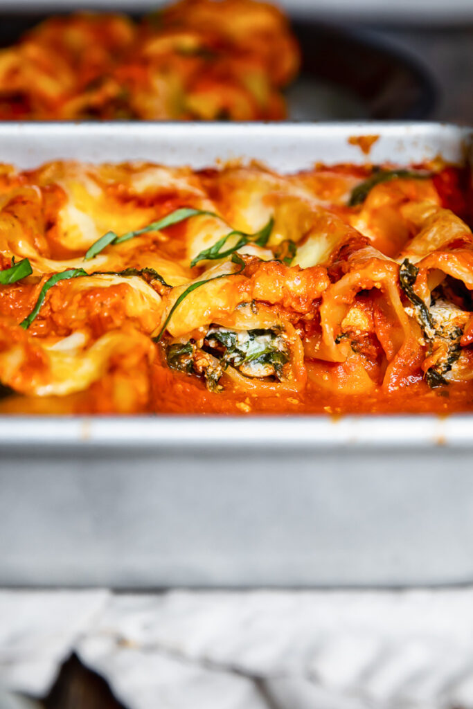 Side view of baked cannelloni in a dish