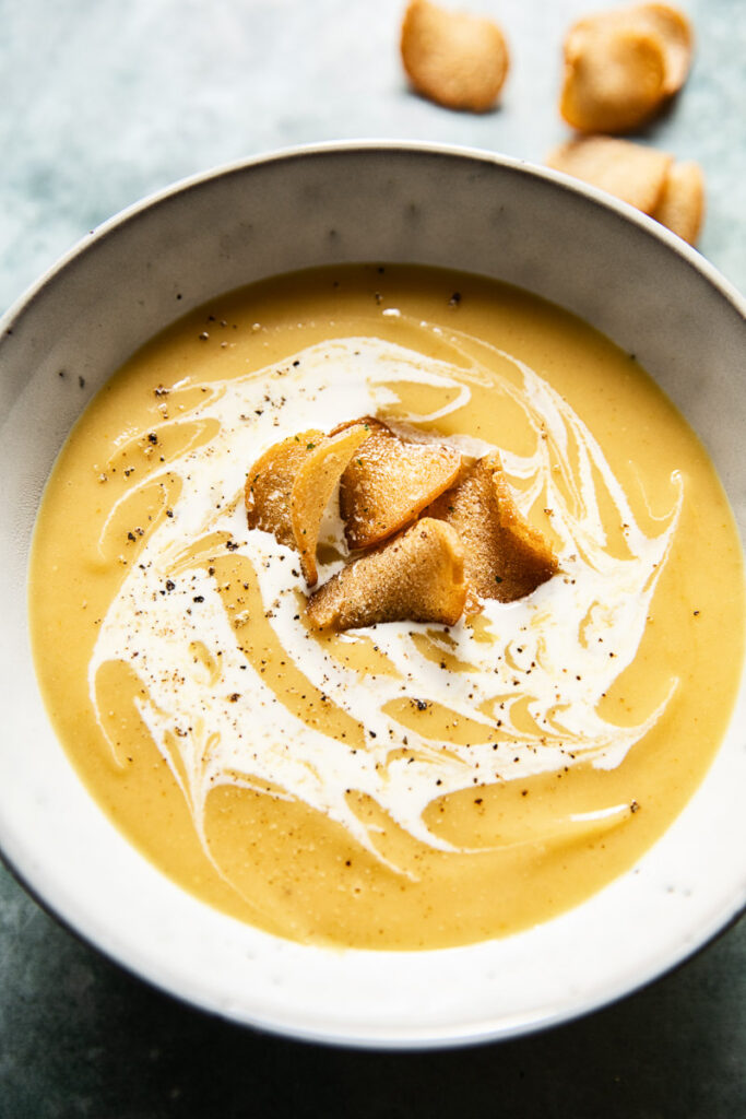 Bowl of curried roasted parsnip soup with croutons