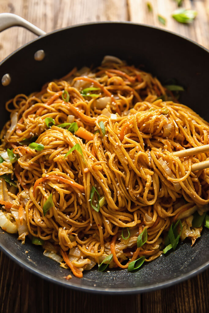 wok full of spicy peanut noodles