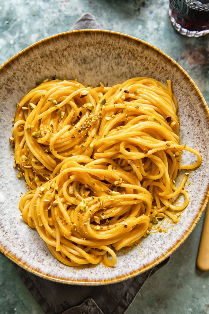 Bowl of roasted butternut squash pasta with pistachio crumb