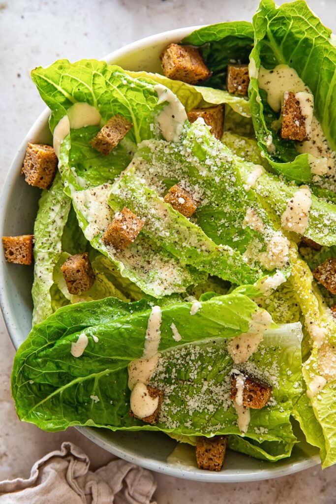 close up of a bowl of Caesar salad with rye croutons