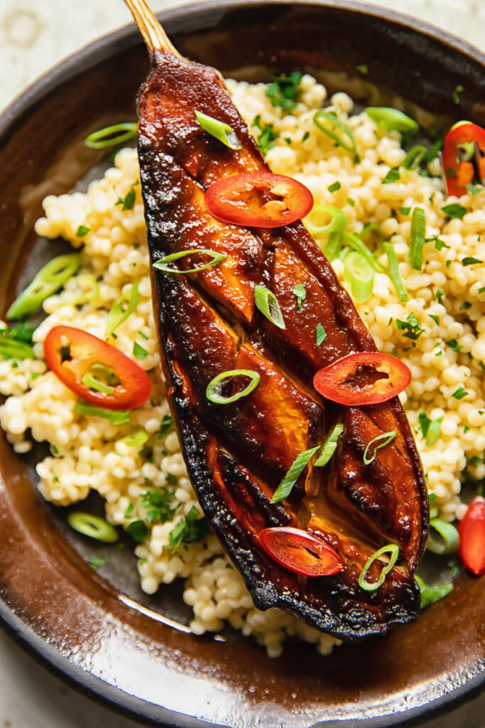 close up of a miso aubergine on a plate with couscous
